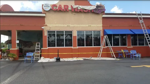 Commercial storefront exterior painting at a car wash in Venice, FL