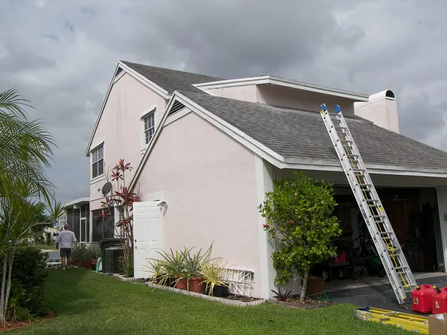 Two-story stucco home exterior repaint in Cape Coral, FL by Kranenburg Painting