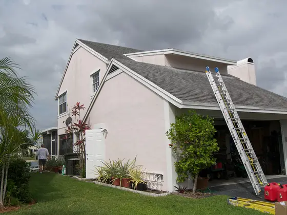 Two-story stucco home exterior repaint in Cape Coral, FL by Kranenburg Painting