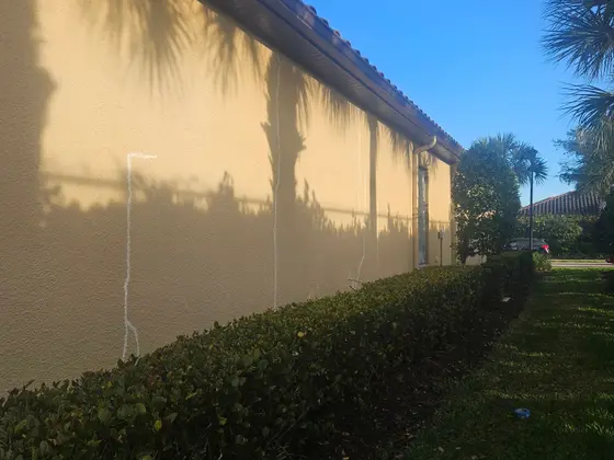 Stucco wall crack repair marked out before exterior painting in Southwest Florida