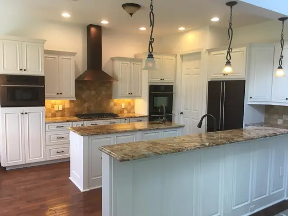 White painted kitchen cabinets with granite countertops in a Southwest Florida home