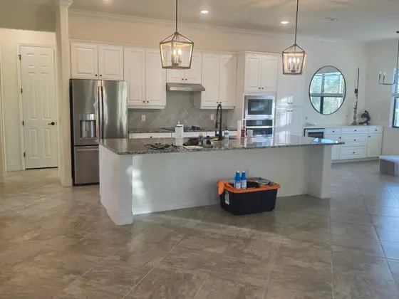 Freshly painted white kitchen cabinets with stainless appliances in an Anna Maria Island, FL home