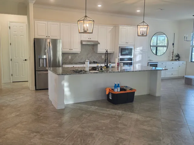 Freshly painted white kitchen cabinets with stainless appliances in an Anna Maria Island, FL home