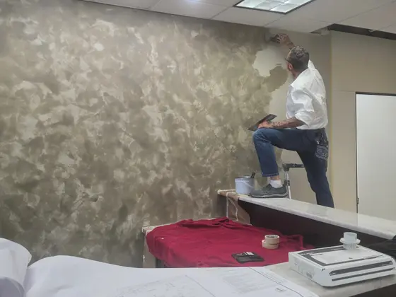 Hand-applied Venetian plaster finish being applied to an interior wall in a Naples, FL home
