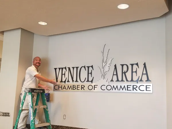 Kranenburg Painting team member completing an interior sign-painting project in Venice, FL