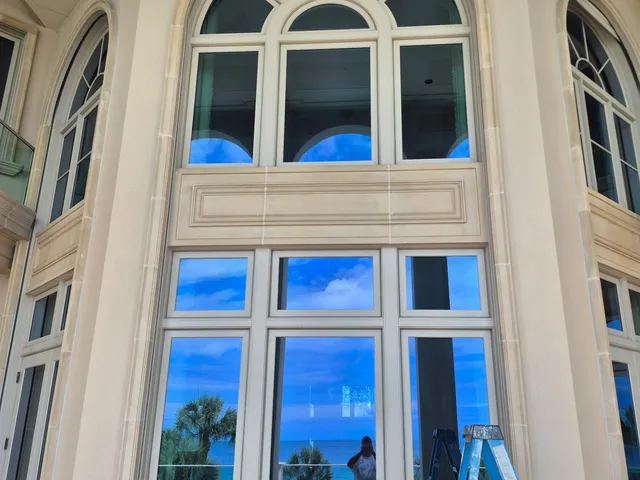 Freshly painted exterior arched window trim overlooking the water at a Palmetto, FL property