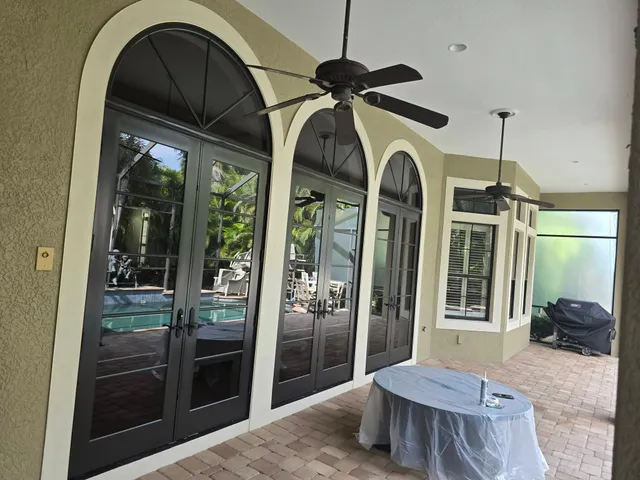 Freshly painted lanai archways and French doors overlooking the pool at a Punta Gorda, FL home