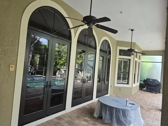 Freshly painted lanai archways and French doors overlooking the pool at a Punta Gorda, FL home